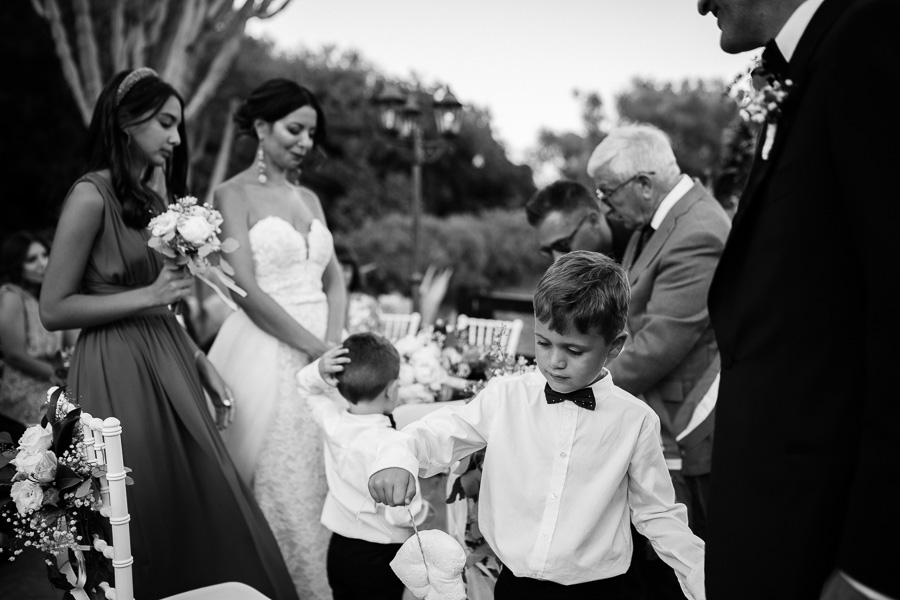 Bambino che gioca con il cuscino delle fedi durante il rito di Matrimonio alla Torre di Scopello