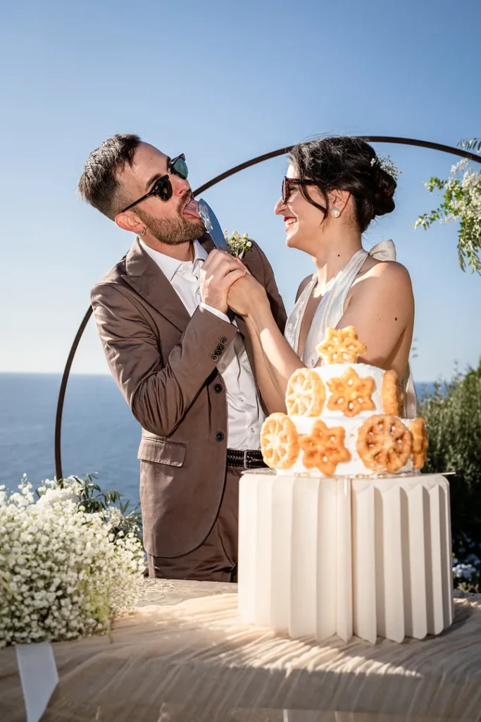 Bride and groom cutting their wedding cake in Pantelleria.