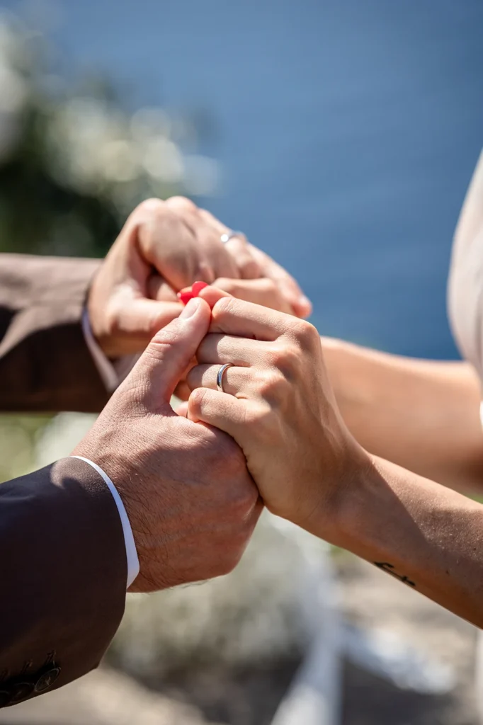 Bride and groom holding hands during their wedding vows.