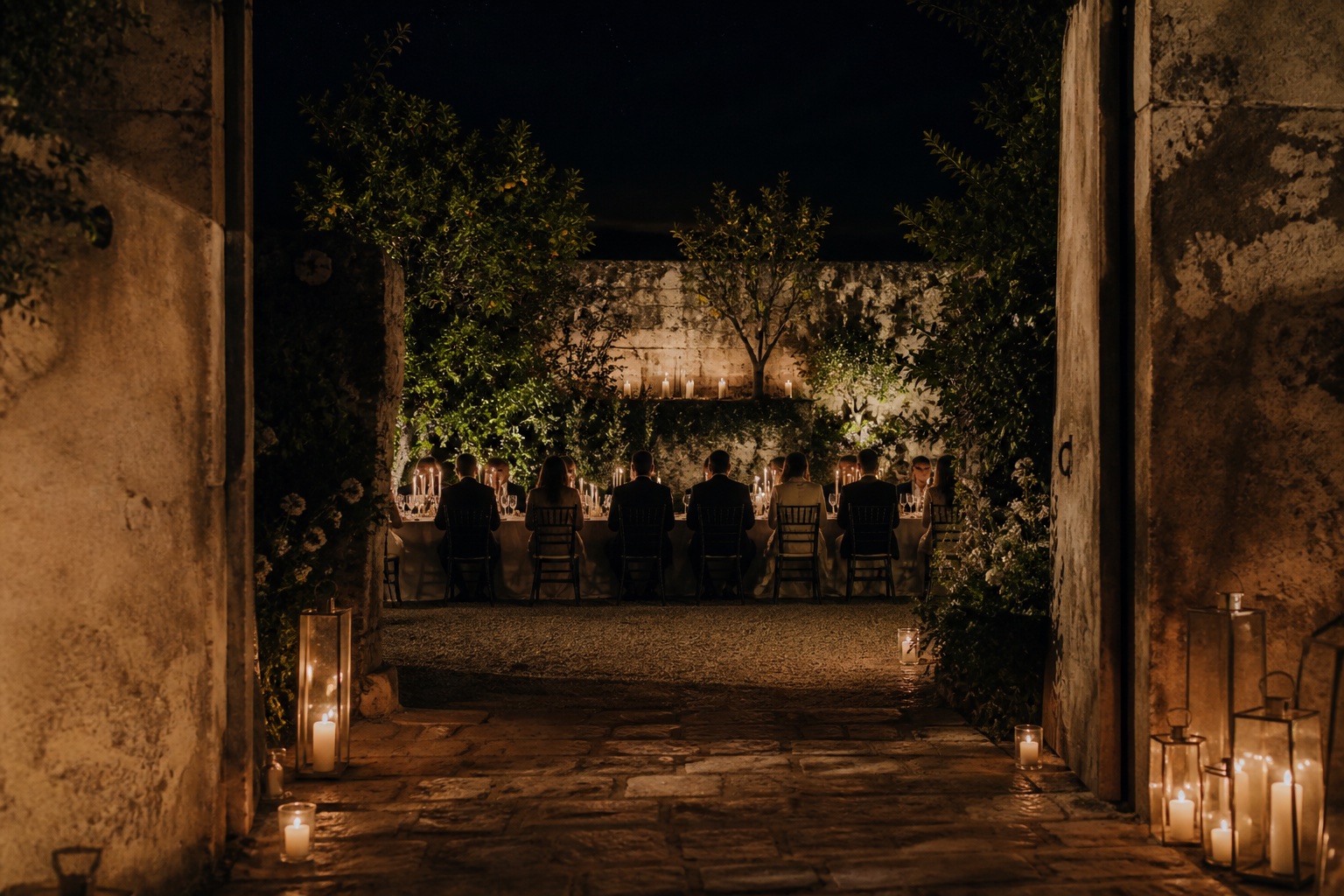 Discreet candlelit wedding reception inside a private walled garden in Sicily