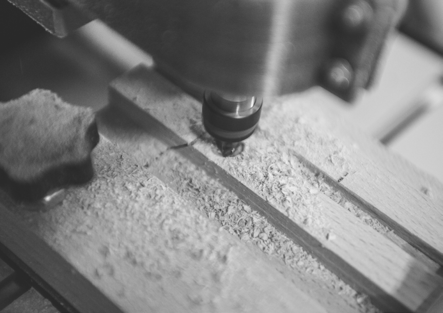 Black-and-white photograph of woodworking in the Lab Service workshop.