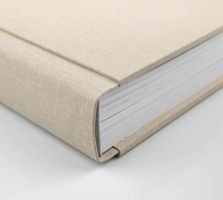 Detail of a cloth-covered wedding album spine and pages.