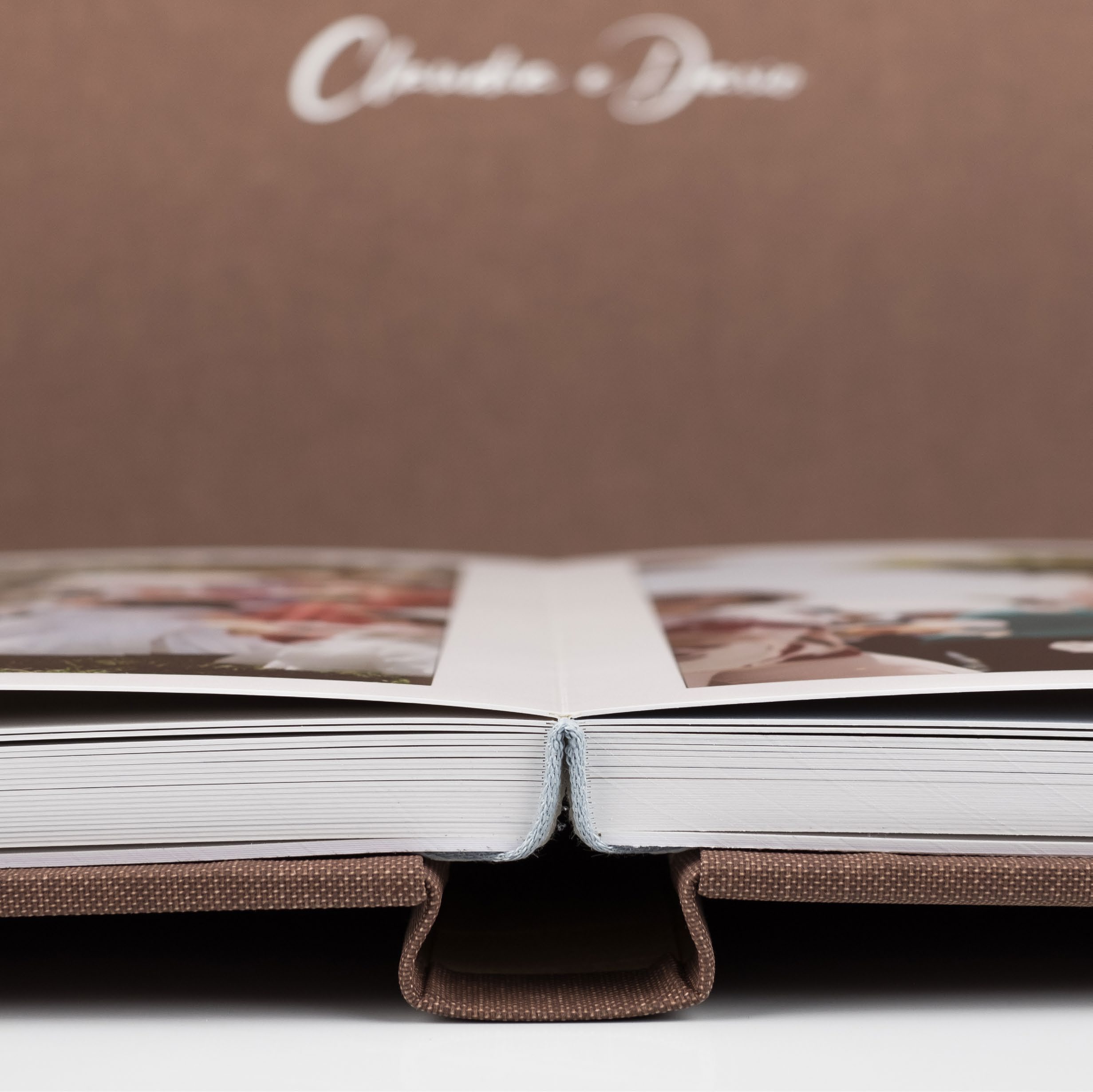 Open wedding album showing its pages and binding.